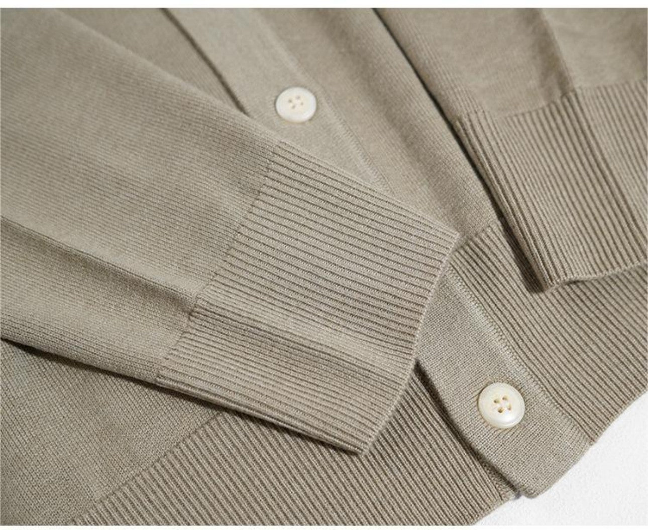 Lay flat detail of ribbed cuff and hem on wool cardigan