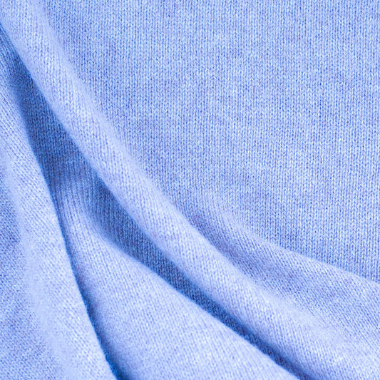 Close-up of a soft blue fabric highlighting cashmere sweaters for luxury fashion appeal