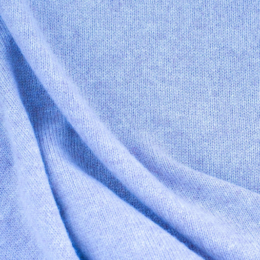 Close-up of a soft blue fabric highlighting Cashmere Sweaters for luxurious fashion appeal.