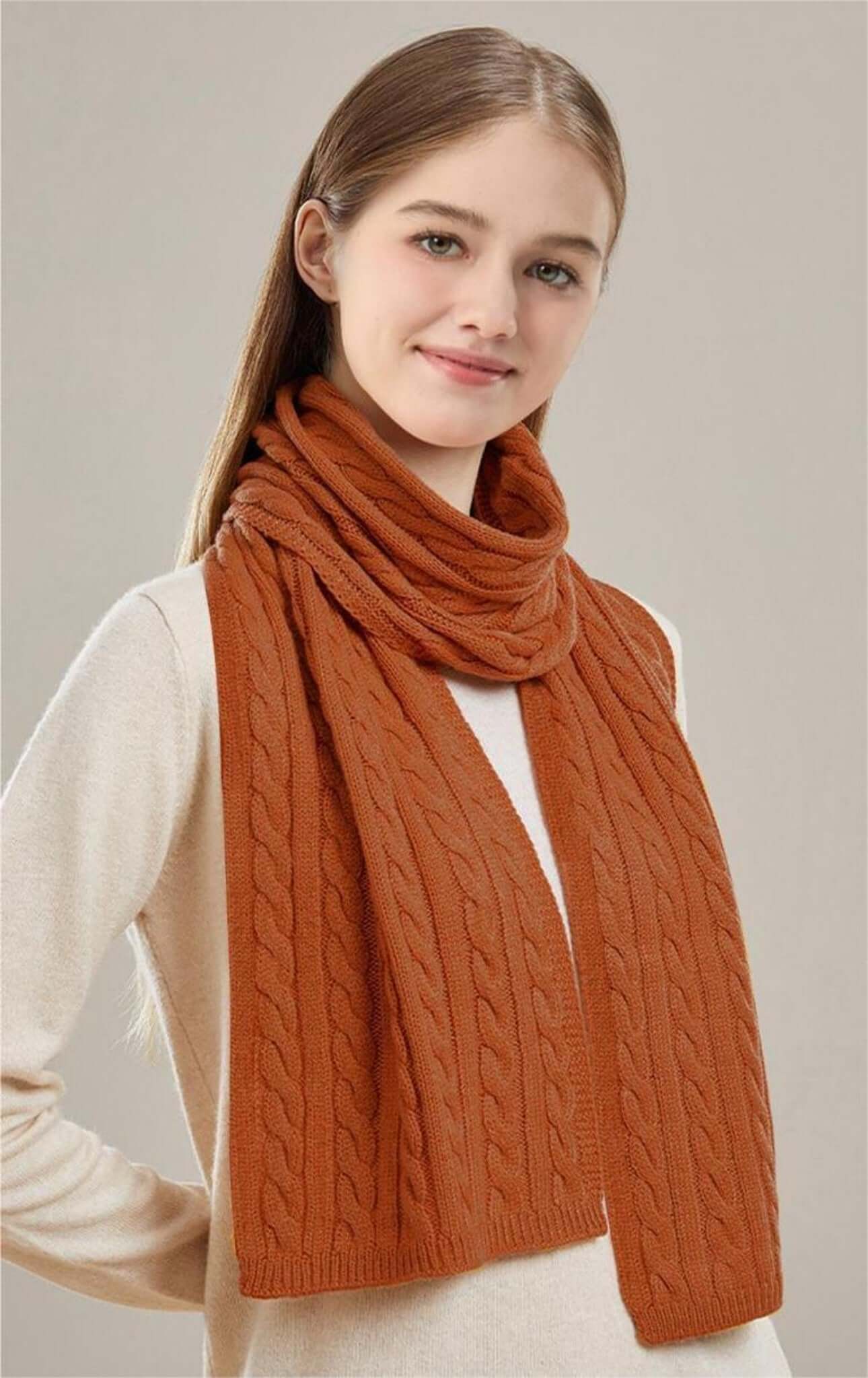 Thick Cable-Knit Scarf OEM modeled by a smiling woman wearing an orange scarf with a cable-knit design.