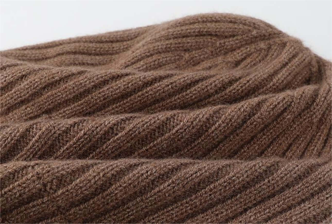 Close-up view of a textured brown knit fabric used in cold proof hat and gloves set.