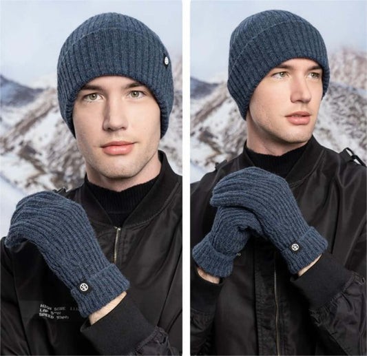 Cold proof hat and gloves set worn by a model against a snowy mountain backdrop, showcasing winter knitwear for men.