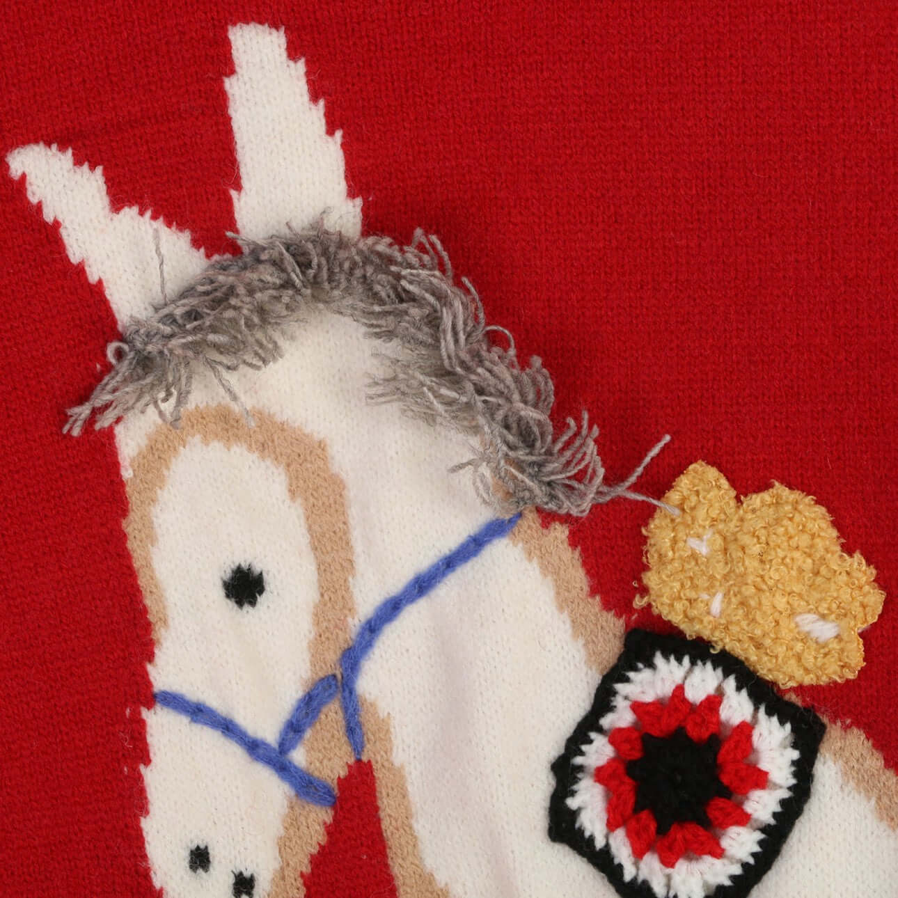 Intarsia pullover sweater manufacturer close-up of running pony intarsia motif