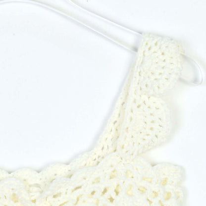 Hand Crochet Sleeveless Top Manufacturer | Detailed view of the crochet pattern and adjustable strap on a white top.