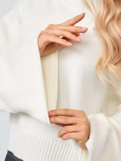 Close-up of a woman wearing a Bell Sleeve Sweater, showcasing the mid neck and flared cuff details in white.