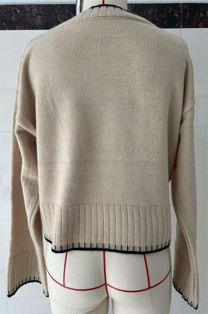 Cropped Loose Sweater OEM in beige with black trim, showcasing the back design and ribbed hem.
