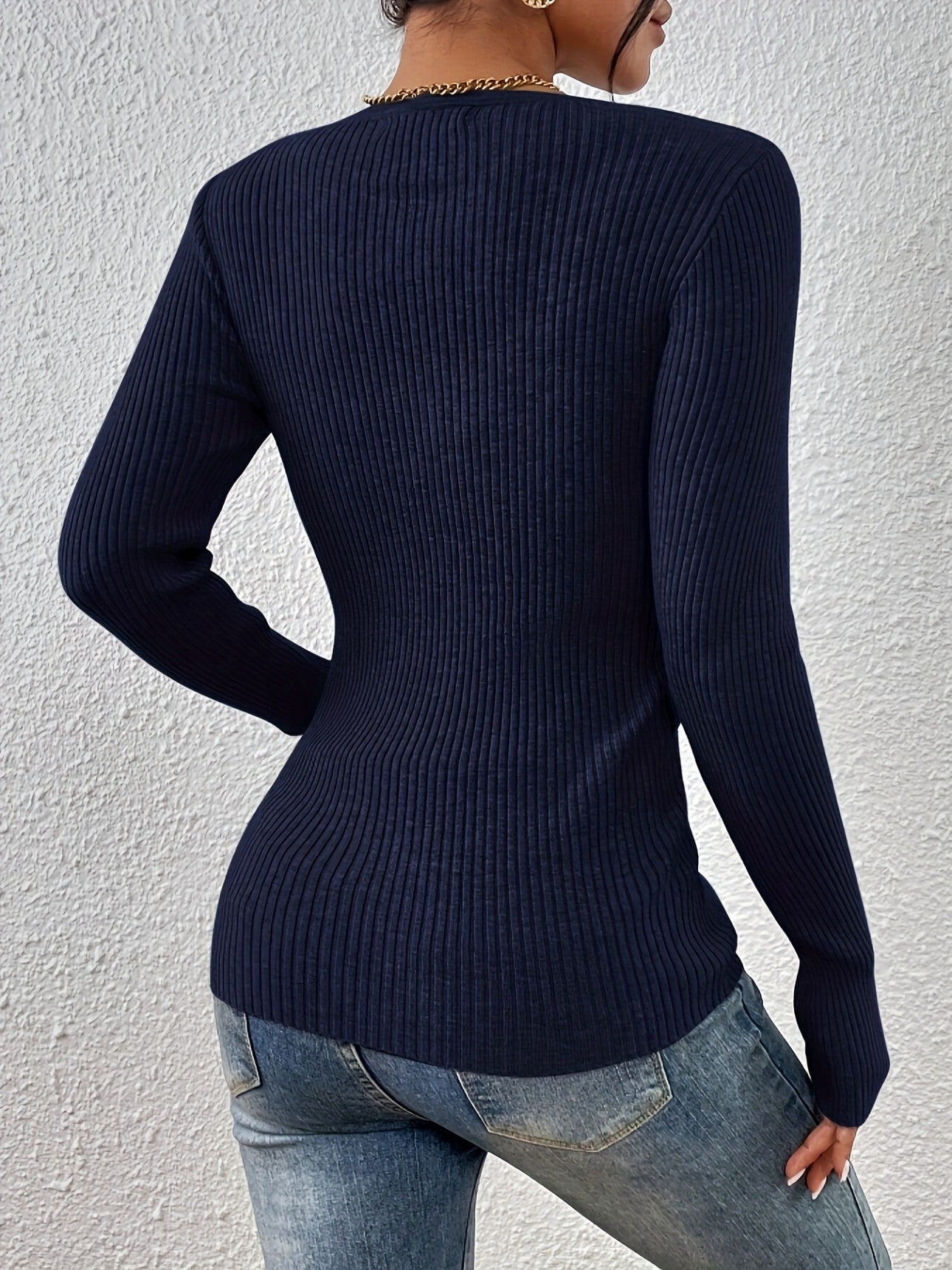 Back view of navy fitted sweater on model