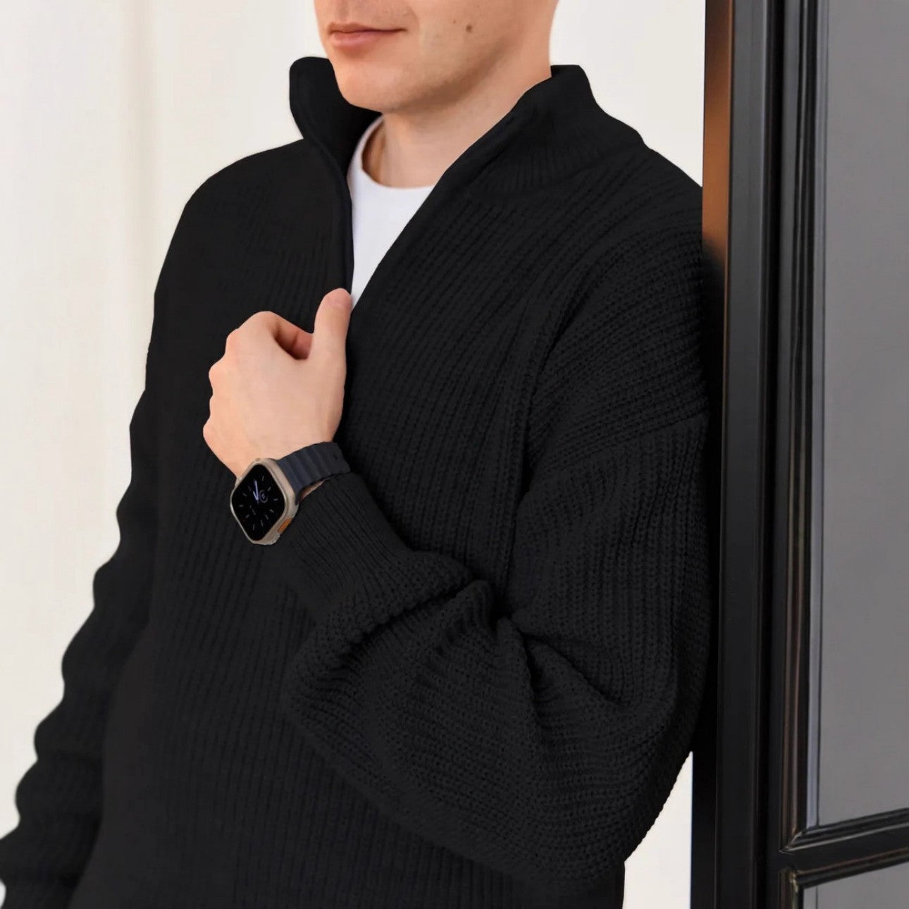 Side view of model wearing black half zip sweater