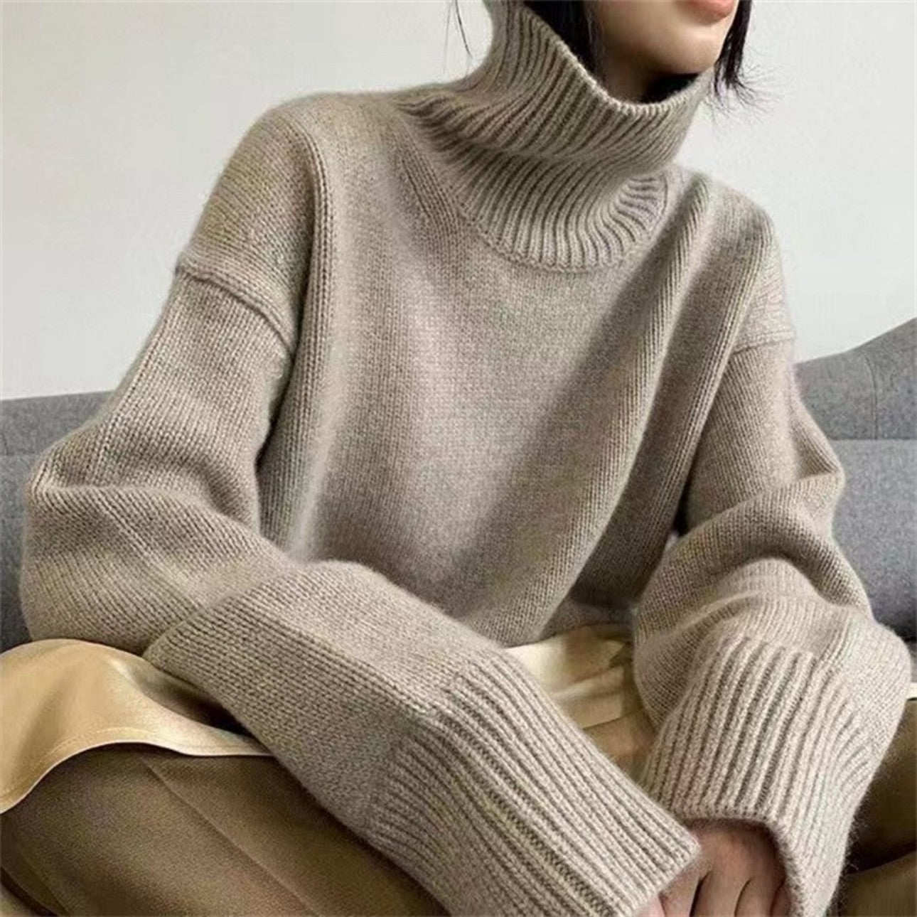 Woman wearing high neck sweater in apricot, front view