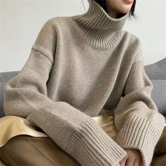Woman wearing high neck sweater in apricot, front view
