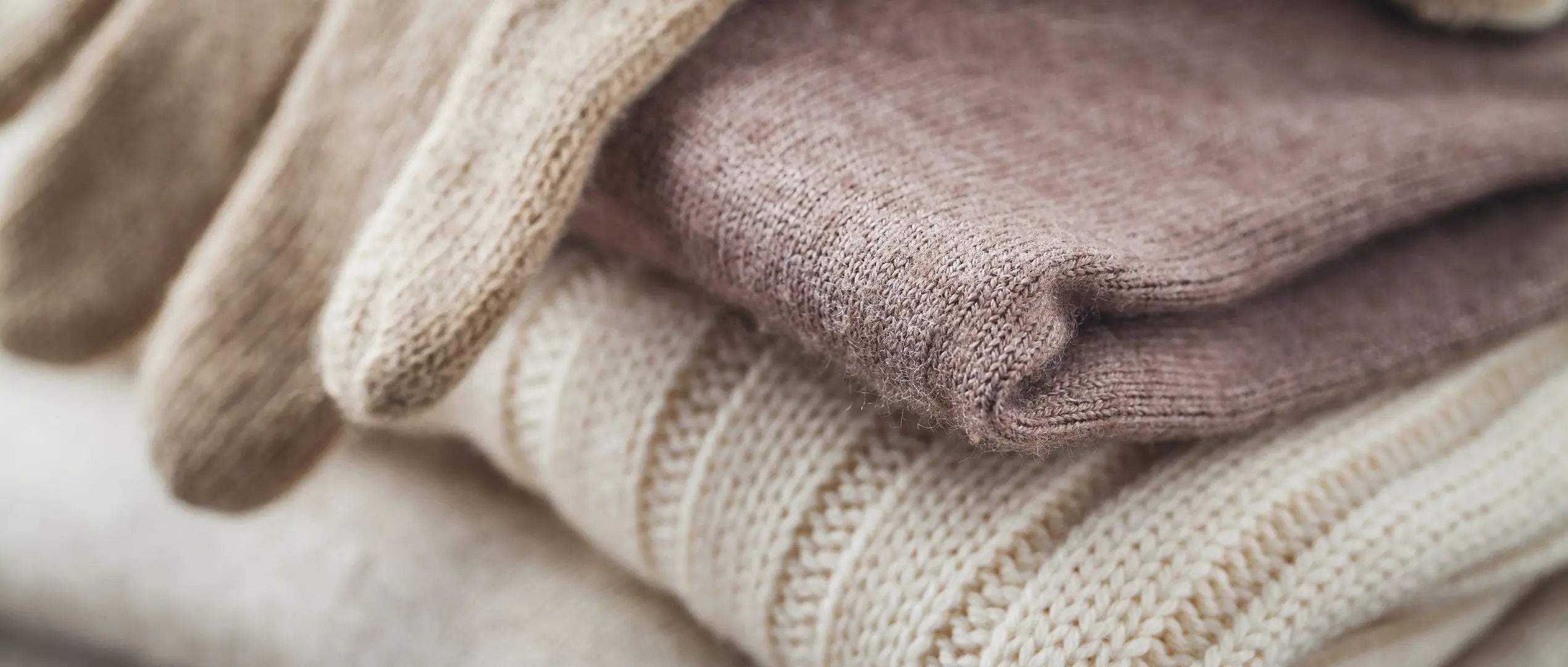 Flatlay of knit sweater and gloves set, ideal for seasonal retail inventory