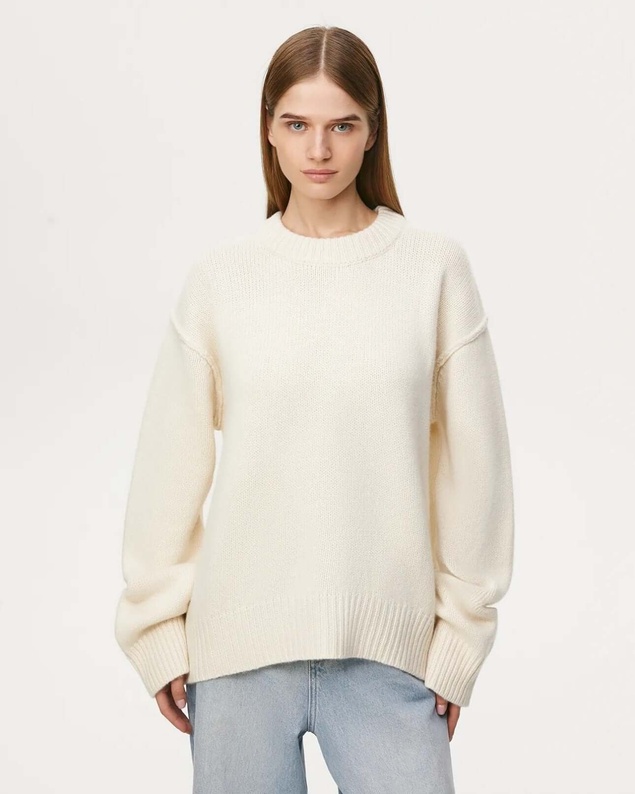 Front view of beige long sleeve round neck sweater on female model.