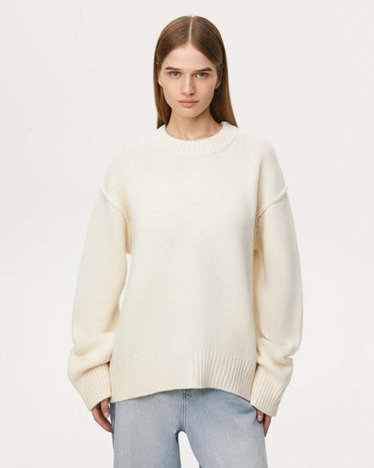 Front view of beige long sleeve round neck sweater on female model.