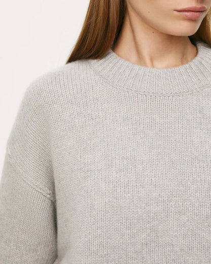 Close-up of Women's Long Sleeve Round Neck Sweater, drop shoulder knitwear in light gray.