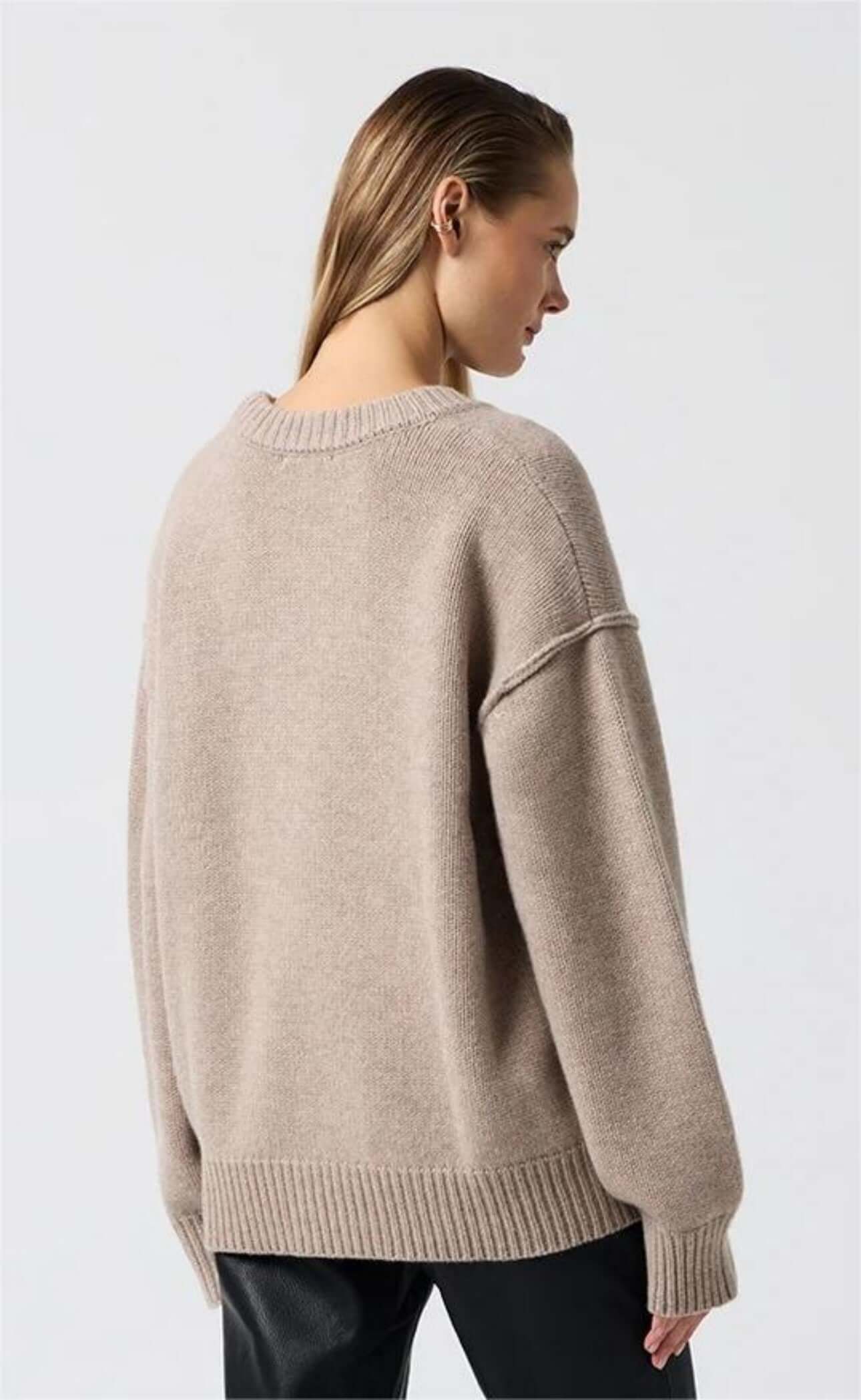 Back view of wheat long sleeve round neck sweater on model.