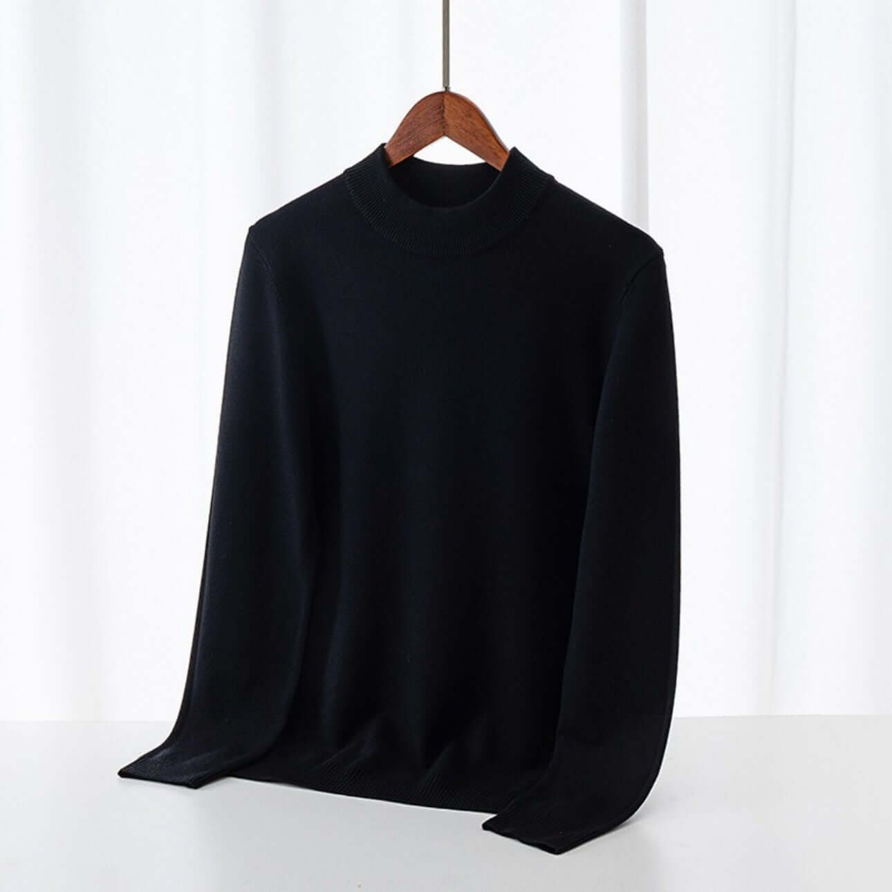 Men's Wool Sweater OEM - Thick round-neck black sweater hanging on display.