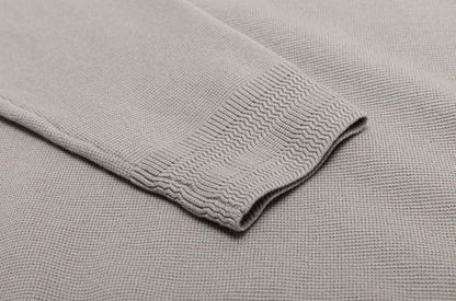 Close-up of the sleeve detailing of a Men's Wool Sweater OEM in light gray, showcasing the knitted texture and ribbed cuff design.