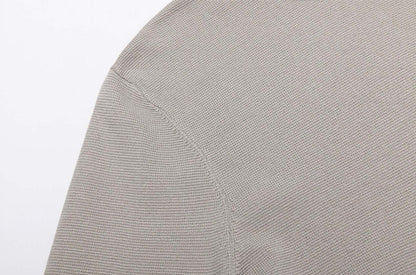 Close-up of fabric texture of Men's Wool Sweater OEM in a soft gray color, showcasing knit detail.