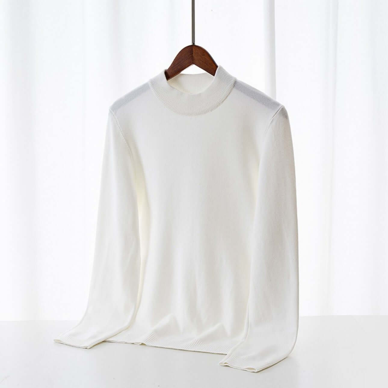 Men's Wool Sweater OEM - Thick round-neck white sweater displayed on a hanger against a light background.