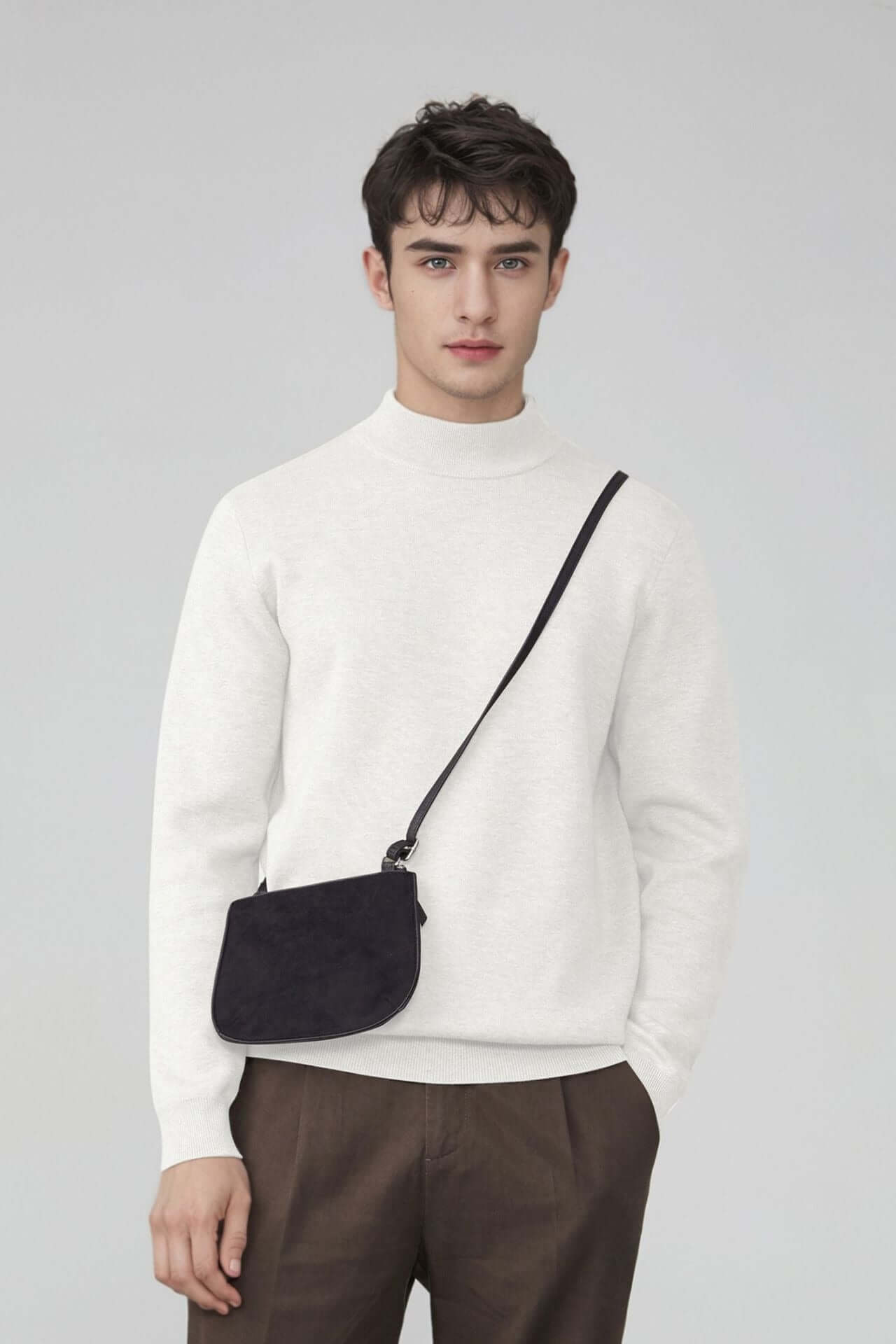 Men's Wool Sweater OEM shown on model wearing a white thick round-neck sweater with a black shoulder bag.