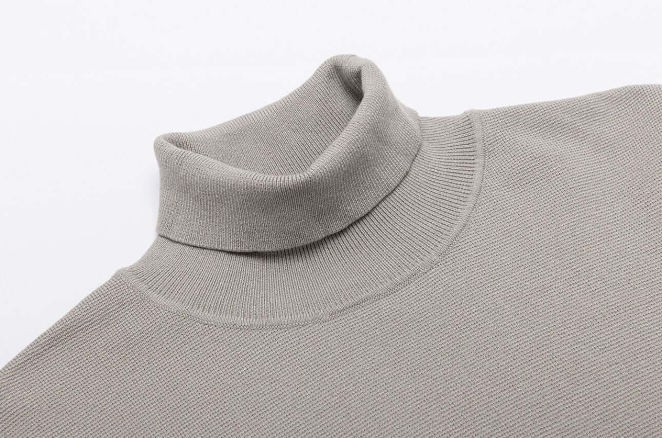 Men's Wool Turtleneck OEM - Thick high neck sweater in a soft gray fabric, showcasing its classic design and comfort.