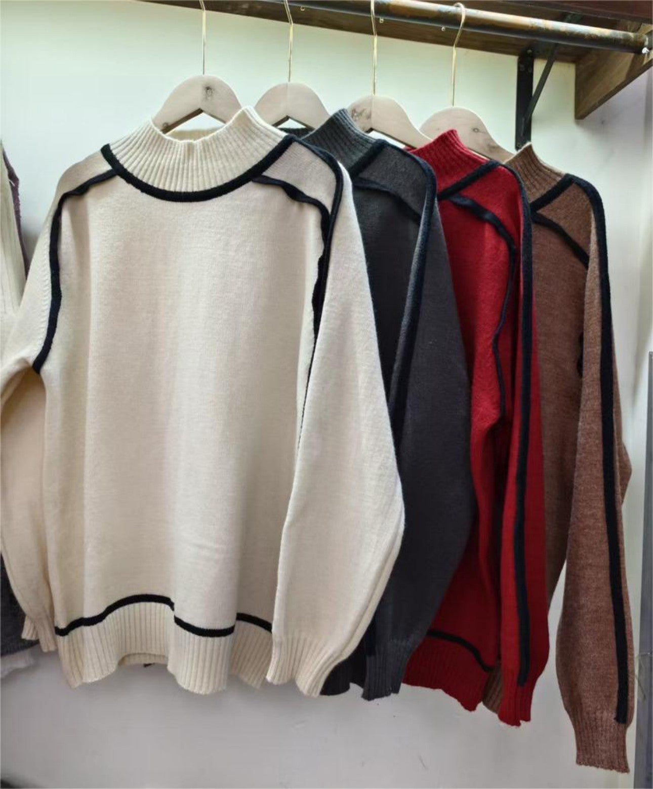 Multiple color options of new sweater on hanger for wholesale