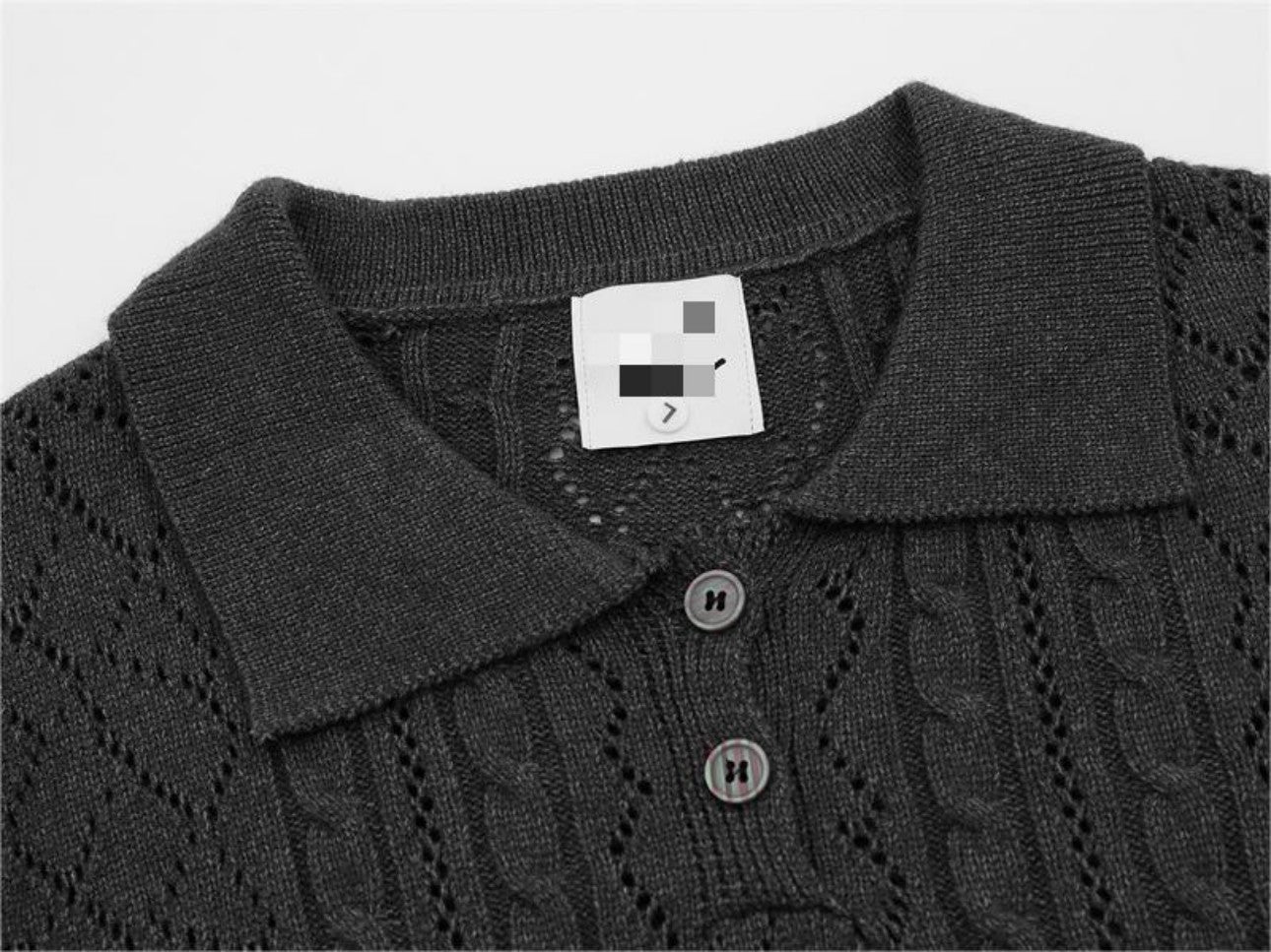 Polo collar detail on dark gray sweater close-up
