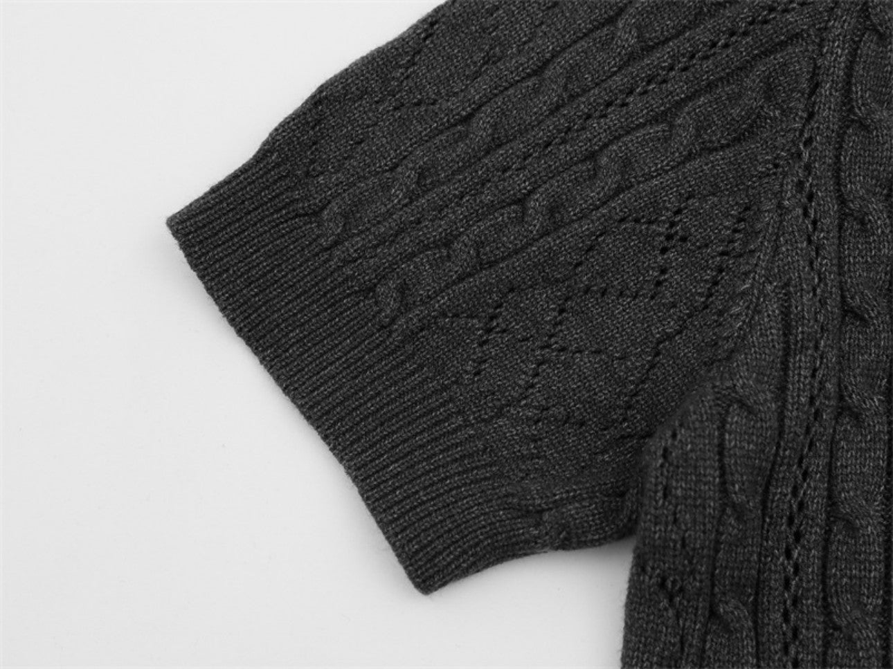 Sleeve cuff detailing on dark gray polo collar sweater