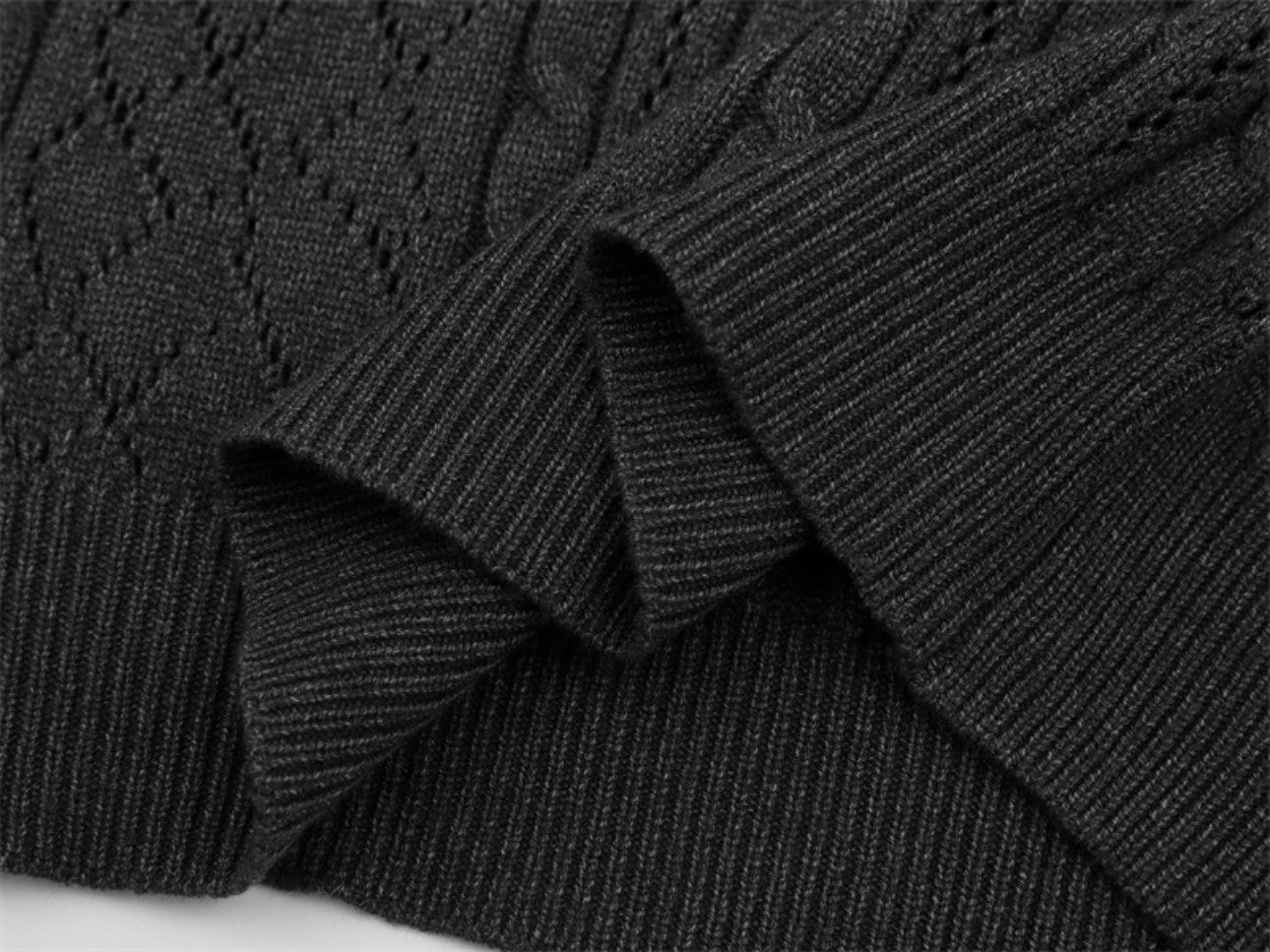 Bottom hem construction on dark gray polo collar sweater