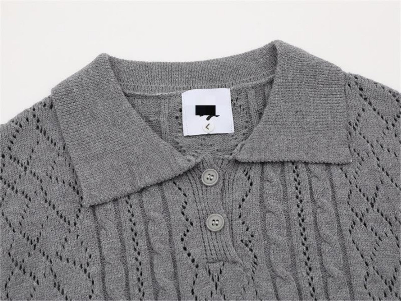 Close-up detail of polo collar on gray sweater