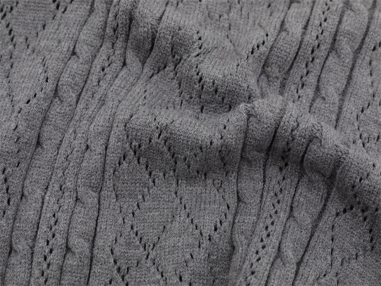Fabric texture close-up of gray polo collar sweater