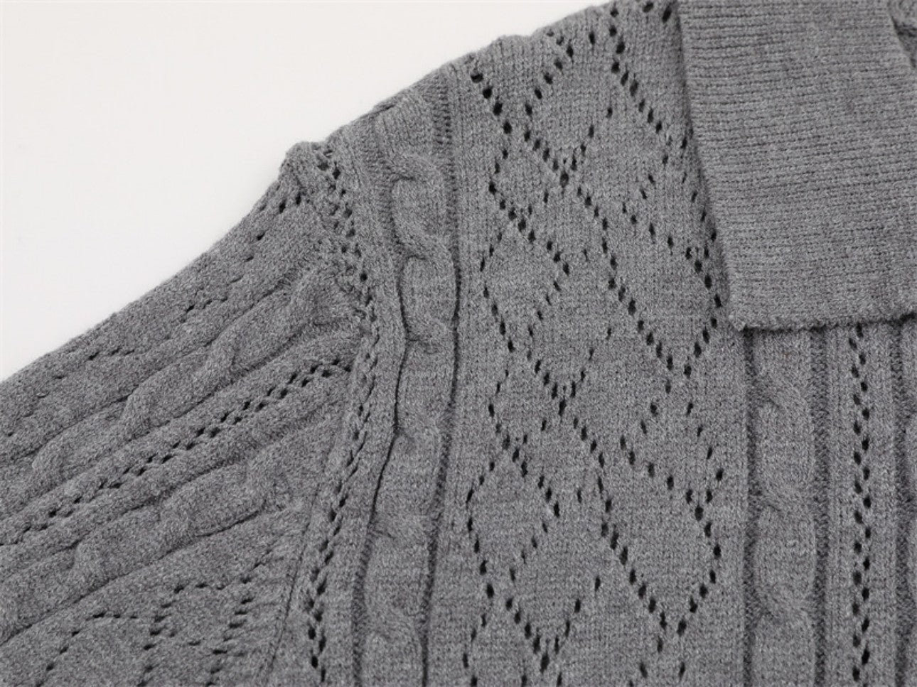 Shoulder construction detail on gray polo collar sweater