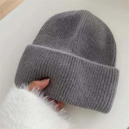 Warm Hat OEM | Women's Rabbit Hair Beanie with Folded Brim in gray, showing a hand holding the cozy knit design.