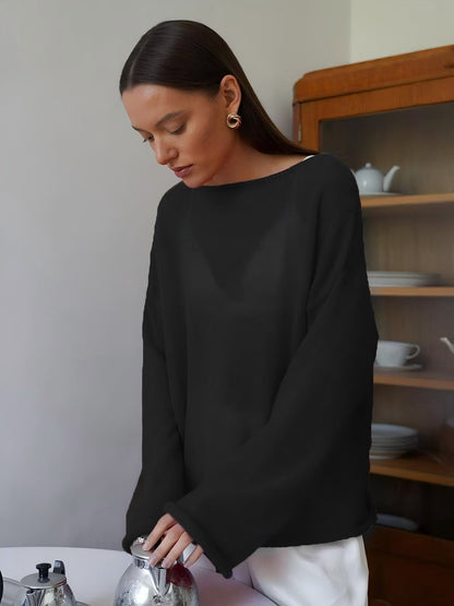 Side view of model wearing dark gray sheer sweater