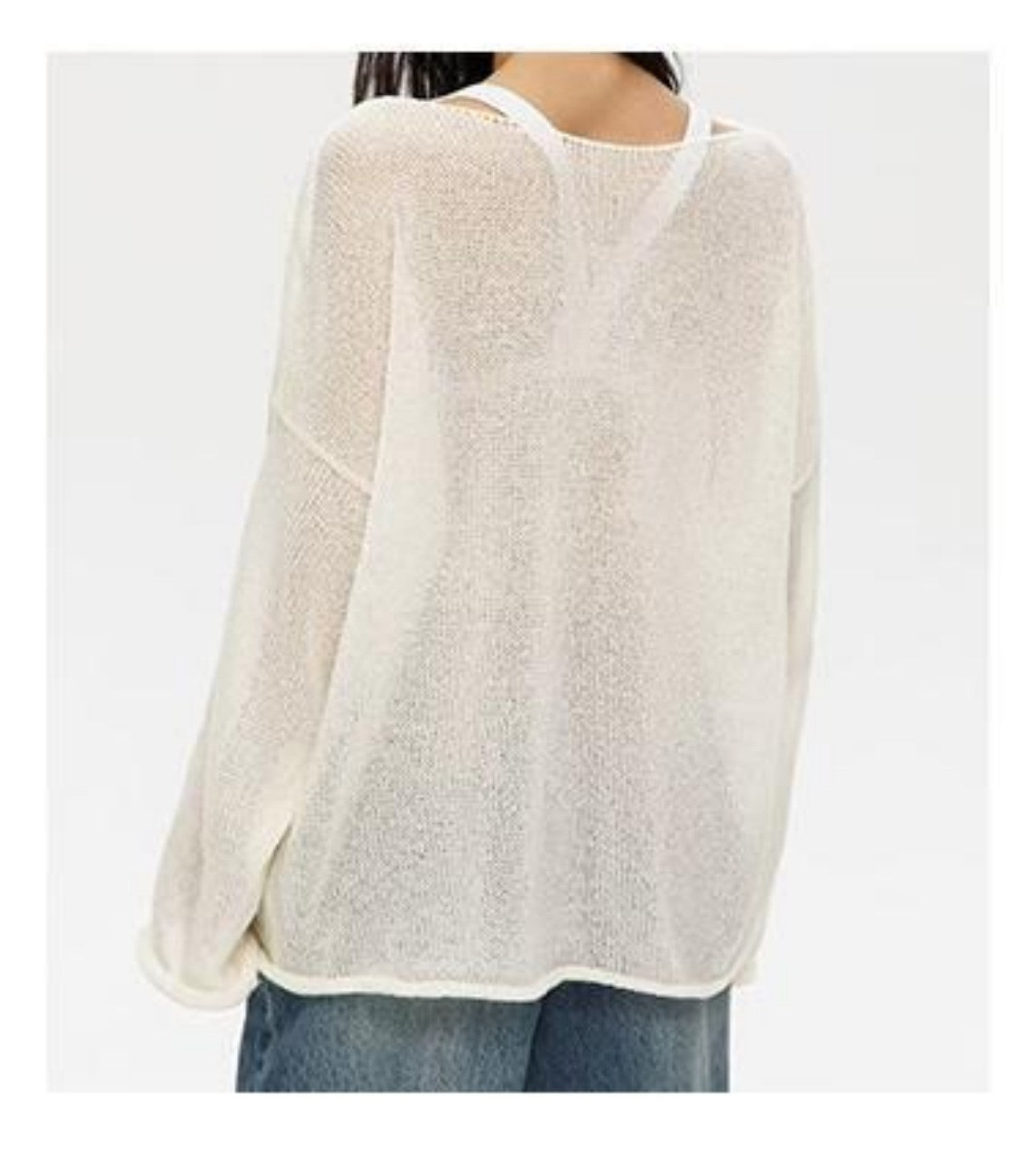 Back view of white sheer sweater with round neck on model