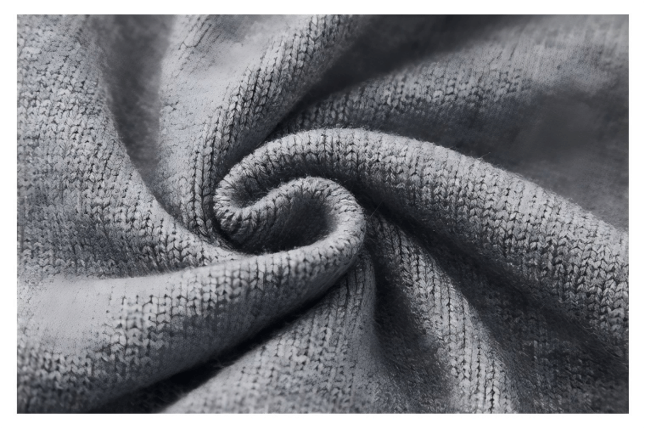 Close-up showing the knit fabric texture of the sleeveless sweater.