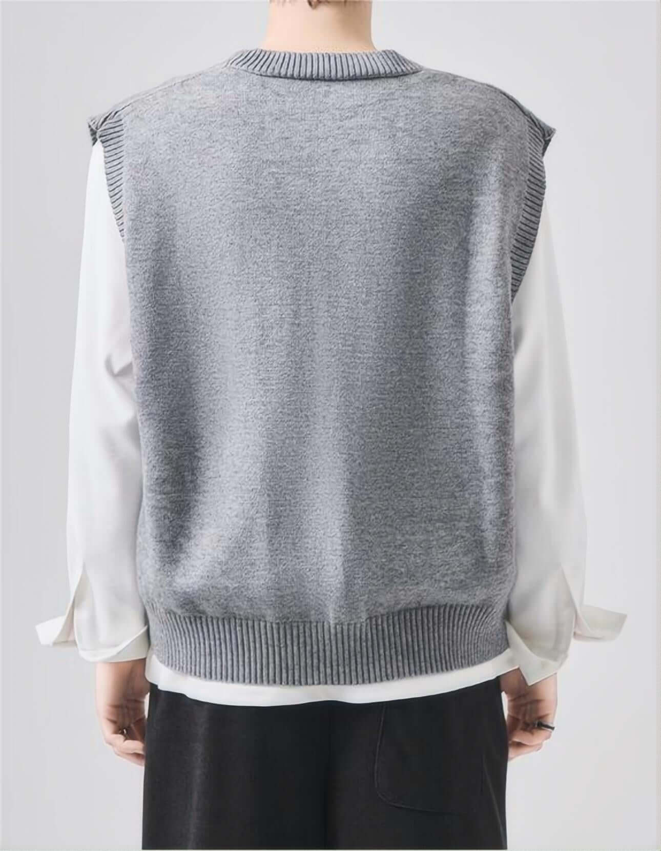 Back view of man wearing gray sleeveless sweater.