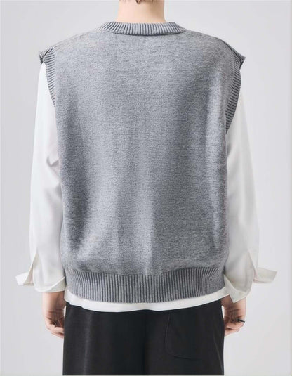 Back view of man wearing gray sleeveless sweater.
