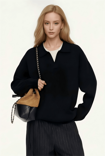 Unisex Cashmere Sweater OEM in black mock neck style, model holding a stylish handbag.