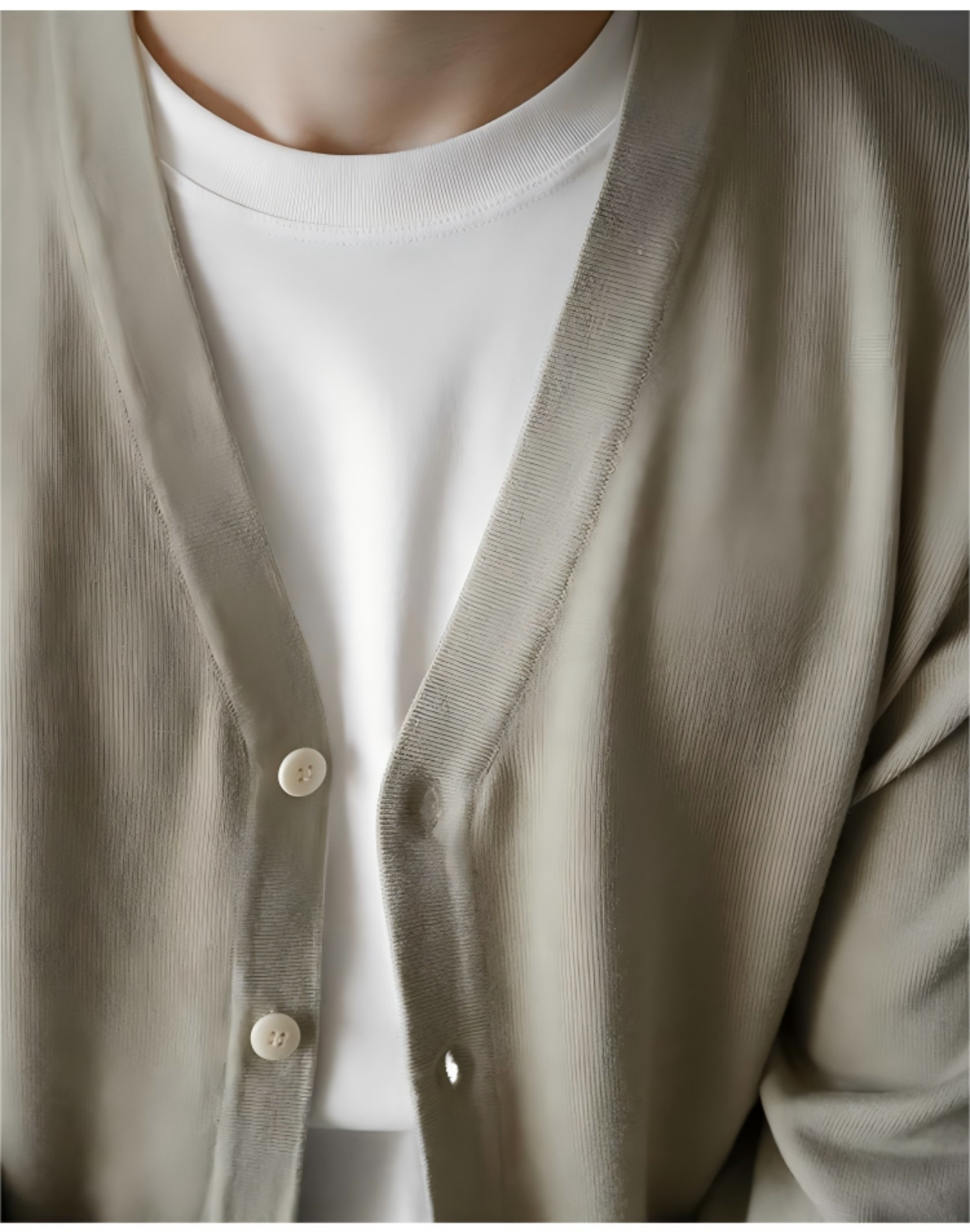 Close-up detail of the V-neck collar on apricot wool cardigan