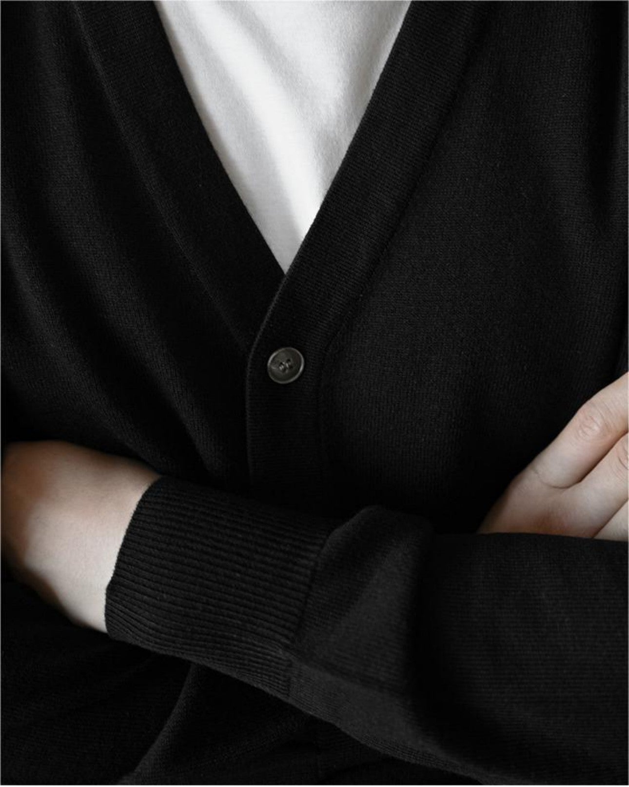 Close-up detail of the V-neck collar on apricot wool cardigan