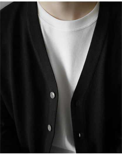 Detail of black wool cardigan showing open V-neck collar
