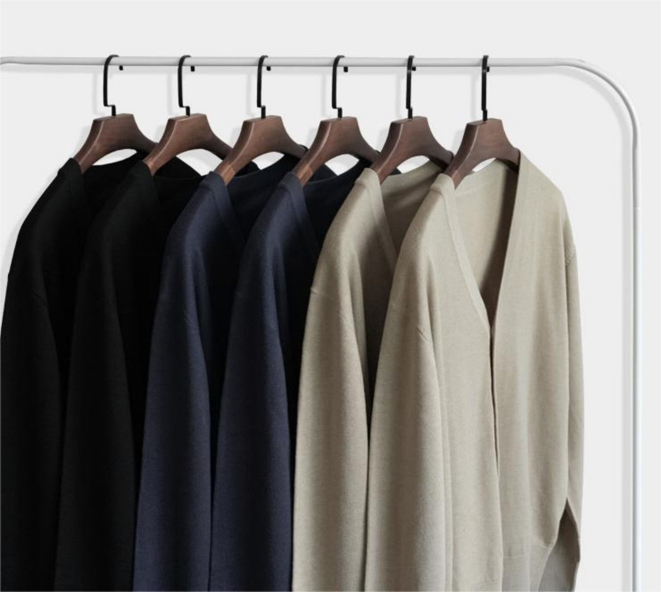 Apricot and black color options of wool cardigan on hanger for wholesale